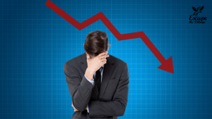 Poor line graph with dips over business man with his head in his hands